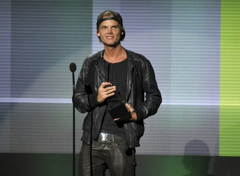In this Nov. 24, 2013 file photo, Avicii accepts the award for favorite artist - electronic dance music at the American Music Awards in Los Angeles. Swedish-born Avicii, whose name is Tim Bergling, was found dead, Friday April 20, 2018, in Muscat, Oman. He was 28. 