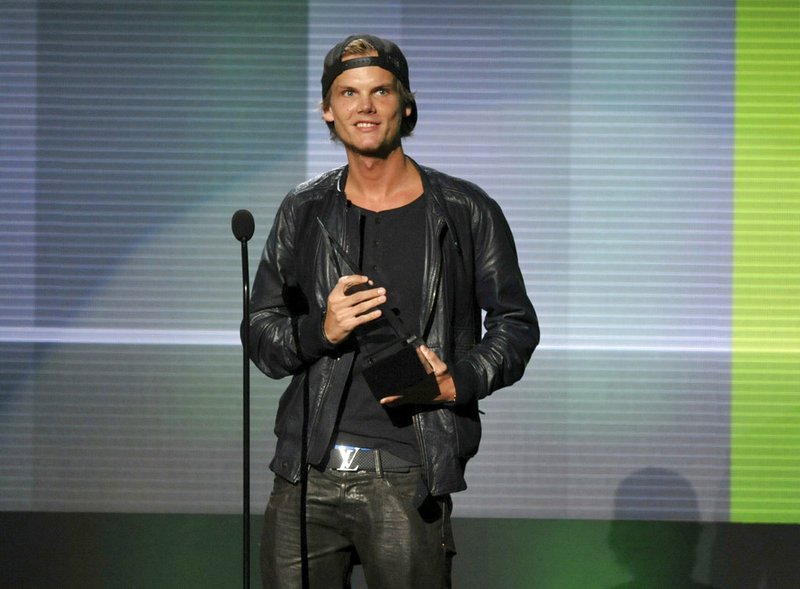 In this Nov. 24, 2013 file photo, Avicii accepts the award for favorite artist - electronic dance music at the American Music Awards in Los Angeles. 