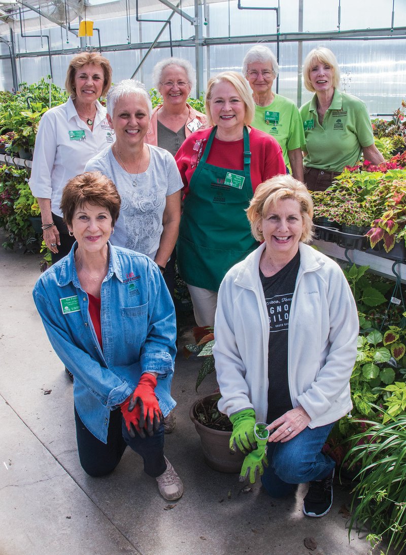 Garland County Master Gardeners working with the plants in the greenhouse at Lake Hamilton High School are, front row, Claudette Cooper, left, and Jennifer Jennings; middle row, Carol Scrivner, left, and Sheila McLarty; and back row, from left, Claudette Cooper, Barbara Smith, Marty Lynch and Bev Merritt. The Master Gardeners will hold their annual plant sale and garden show Saturday at the Garland County Fairgrounds.