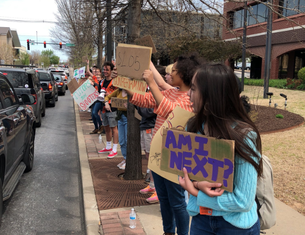 Students hold signs during a protest Friday, April 20, 2018, in front of the Washington County Courthouse in Fayetteville.

