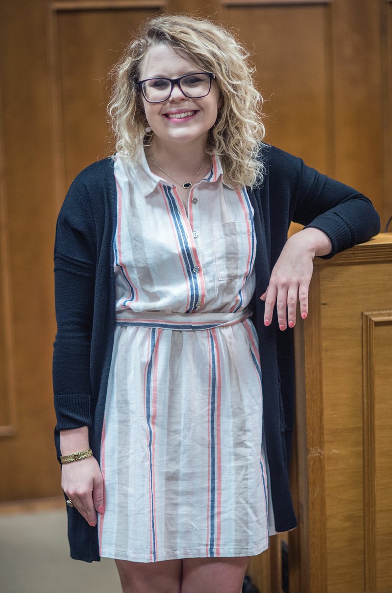 Leia Smith, a daughter of Ray and Sherrie Benton of Cabot, stands in the Faulkner County Courthouse in Conway, where she works as development coordinator for the Children’s Advocacy Alliance.  Smith, a senior at the University of Central Arkansas, was honored with two championships earlier this month in Spokane, Wash., from the International Public Debate Association.