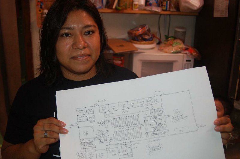 Teresa Sandoval, owner of a bakery and grocery store and director of religious education at St. Luke’s Catholic Church in Warren, holds a fl oor plan for the new church and classrooms that will move into the building that housed the Bradley County Farmers Association co-op.  