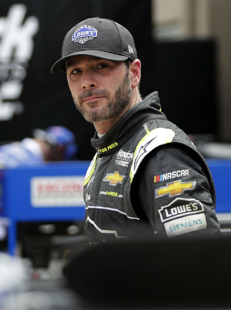Jimmie Johnson walks out of the garage area after a practice session for a NASCAR Cup series auto race in Fort Worth, Texas, Friday, April 6, 2018. (AP Photo/Tony Gutierrez)