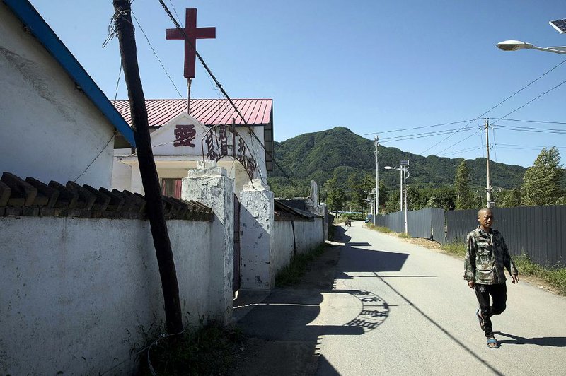 A man walks past a church in the Chinese border town of Jian in northeastern China’s Jilin province.
