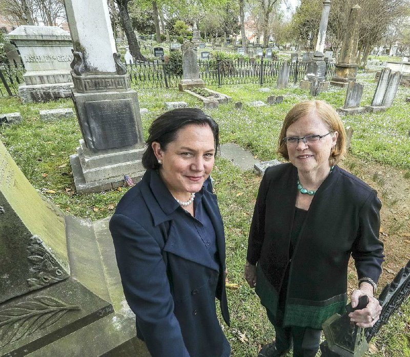 Ellison Poe (left) and Sarah Hopkins stand near one of their favorite spots at the history-fi lled and scenic Mount Holly Cemetery. They are in charge of this year’s fundraising picnic. 
