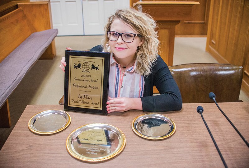 Leia Smith, a Cabot High School graduate and a senior at the University of Central Arkansas in Conway, displays the plaque and silver trays she received from the International Public Debate Association at a tournament in Spokane, Wash. She won two national honors as season-long professional-division debate and speaking champion for 2017-2018.