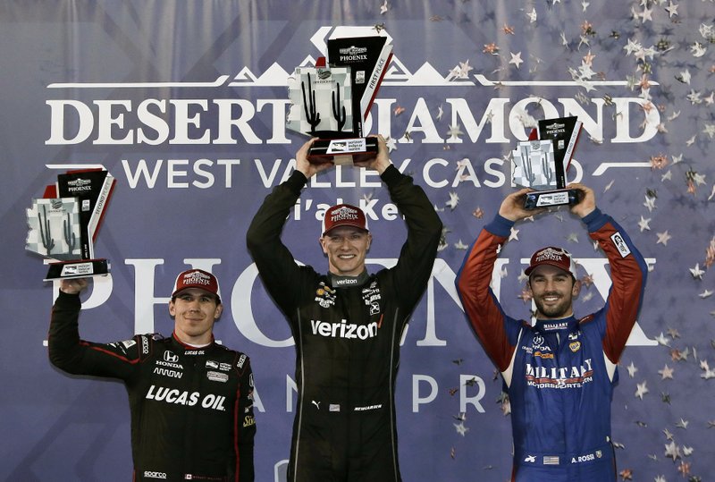 Josef Newgarden, middle, who won the race, celebrates with second-place Robert Wickens, left, and third-place Alexander Rossi after the IndyCar auto race Saturday, April 7, 2018, at Phoenix International Raceway in Avondale, Ariz. (AP Photo/Rick Scuteri)