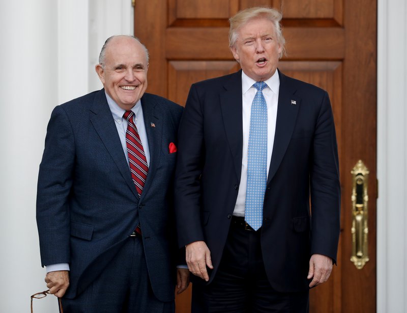 FILE - In this Nov. 20, 2016, file photo, then-President-elect Donald Trump, right, and former New York Mayor Rudy Giuliani pose for photographs as Giuliani arrives at the Trump National Golf Club Bedminster clubhouse in Bedminster, N.J. Giuliani is joining the legal team defending President Donald Trump in the special counsel's Russia investigation. That's according to a statement from Trump personal attorney Jay Sekulow. (AP Photo/Carolyn Kaster, File)