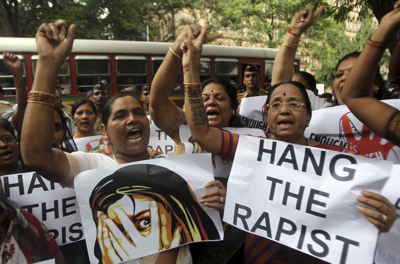 In this Aug 23, 2013 file photo, Indian activists hold placards demanding rapists be hanged as they protest against the gang rape of a 22-year-old woman photojournalist in Mumbai India. India's government has decided to prescribe the death penalty for people convicted of raping girls under the age of 12 to combat an increase in crimes against women. The Press Trust of India news agency reported Saturday, April 21, 2018, that the ordinance is being sent to the president for approval. It will require the approval of Parliament within six months in order the become law. 
