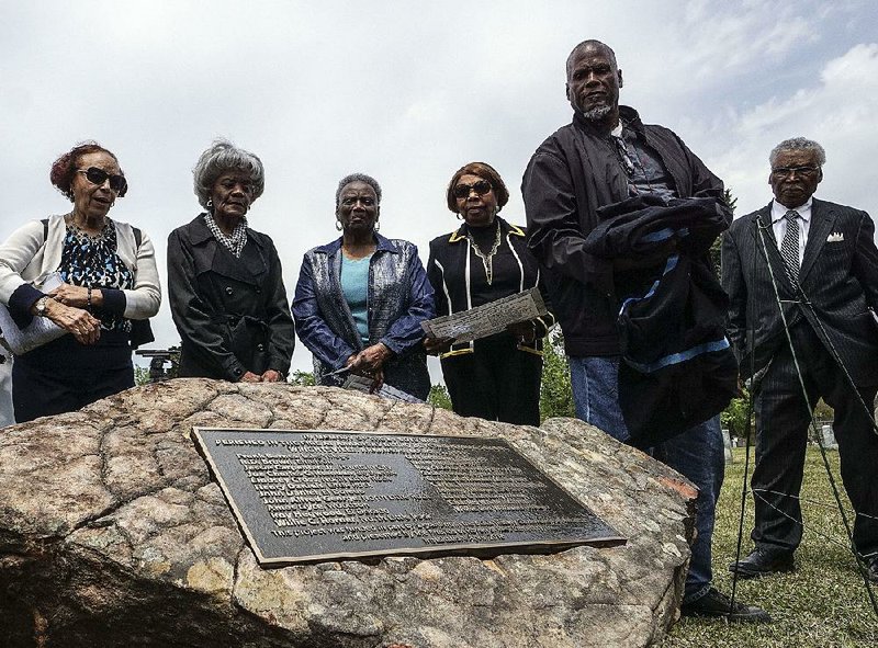 People attend the unveiling Saturday of a bronze marker bearing the names of 21 boys killed in a 1959 fi re at the Arkansas Negro Boys Industrial School in Wrightsville. 