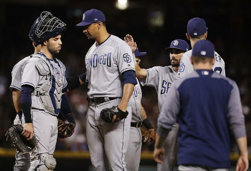 San Diego’s Tyler Ross (center) lost his bid for a no-hitter with two outs in the eighth inning Friday against the Arizona Diamondbacks in Phoenix.  