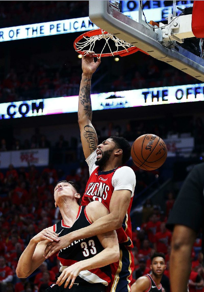 New Orleans Pelicans forward Anthony Davis dunks over Portland Trail Blazers center Zach Collins during the first half Saturday in New Orleans.  