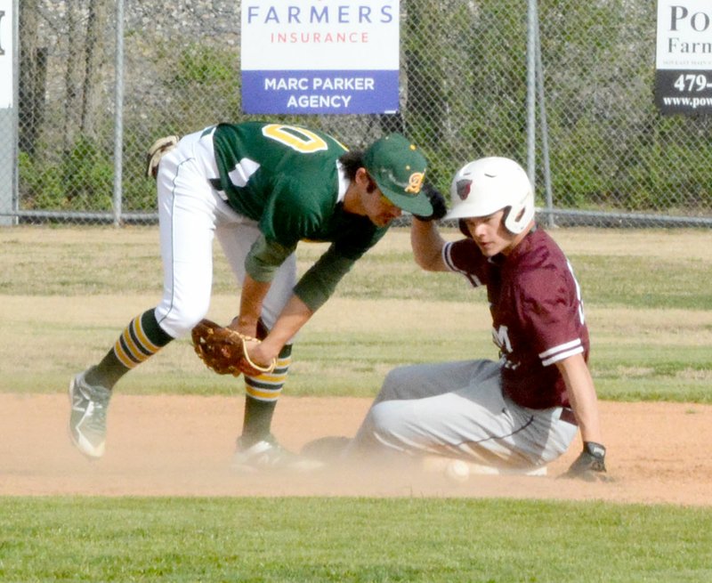 Graham Thomas/Siloam Sunday Alma shortstop Garen Taylor fields the throw at second as Siloam Springs junior Baron Meek slides into second base during Tuesday's game at James Butts Baseball Complex.