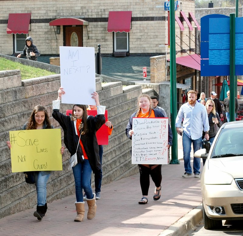 Janelle Jessen/Siloam Sunday Four middle school students led a march of about 15 people protesting in favor of safer gun regulations on Friday morning. The march began at Pour Jon's Coffee and ended at City Hall, where the students gave a series of speeches. About 10 pro-gun counter protesters gathered in a designated area on the other side of City Hall. For more, see Wednesday's edition of the Herald-Leader.