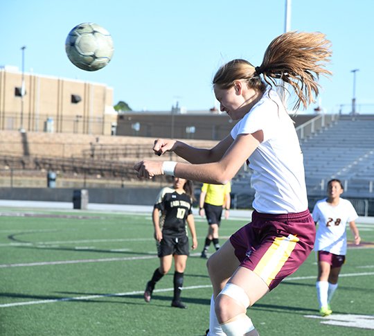 The Sentinel-Record/Grace Brown - Lake Hamilton's Logan Keener (10) heads the ball towards the goal during a game against Hot Springs at Wolf Arena on Friday, April 20, 2018. 