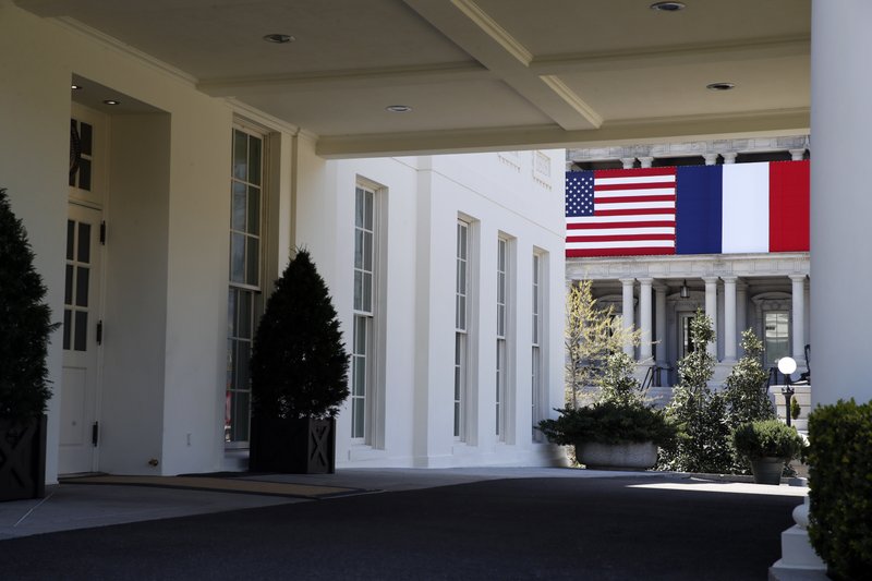 The Associated Press U.S.-FRENCH RELATIONS: The U.S. and French flags are displayed on the Eisenhower Executive Office Building as seen through the portico of the West Wing of the White House on Friday in Washington. President Donald Trump plans to celebrate nearly 250 years of U.S.-French relations by hosting President Emmanuel Macron at a glitzy White House state dinner on Tuesday. It's the first state visit and the first big soiree of the Trump era in Washington.