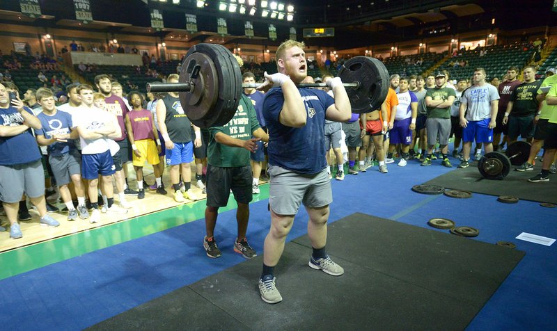 NWA Democrat-Gazette/ANDY SHUPE A large crowd gathers to watch Greenwood's Jon Womack power clean a record 395 pounds Saturday during the 27th annual Arkansas State Weightlifting Championship at Charles B. Dyer Arena in Alma. Visit nwadg.com/photos for more photos from the meet.