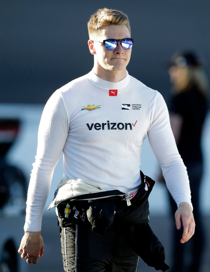 FILE - In this April 7, 2018, file photo, Josef Newgarden walks before an IndyCar auto race at Phoenix International Raceway in Avondale, Ariz. Graham Rahal loves what he's seeing at the top of the IndyCar series standings so far this season. Twenty-something Americans Alexander Rossi, Josef Newgarden and Rahal are lined up neatly at the top heading into Sunday's, April 22, 2018, race at Barber Motorsports Park. (AP Photo/Rick Scuteri, File)