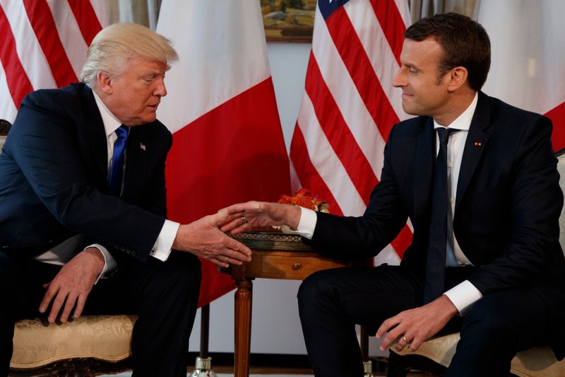 In this May 25, 2017 file photo, US President Donald Trump, shakes hands with French President Emmanuel Macron, right, during a meeting at the U.S. Embassy in Brussels. Macron arrives Monday April 23, 2018 in Washington for the first state visit of Trump’s presidency. The two men have an unlikely friendship, despite strong differences on areas such as climate change. (AP Photo/Evan Vucci, File)