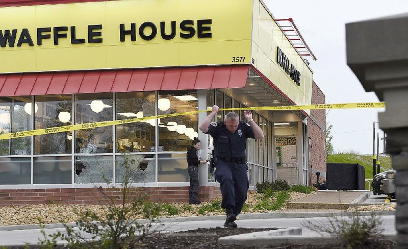 Law enforcement officials work the scene of a fatal shooting at a Waffle House on Sunday in Nashville, Tenn. 
