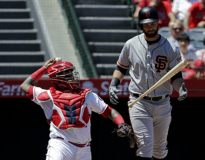 San Francisco Giants’ Brandon Belt reacts after hitting a foul ball during the first inning Sunday against the Los Angeles Angels in Anaheim, Calif. Belt set a record with a 21-pitch at-bat against the Angels’ Jaime Barria. 