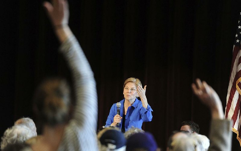 U.S. Sen. Elizabeth Warren takes questions from the crowd at the Cape Cod Regional Technical High School in Harwich, Mass., on Saturday, where the senator hosted a community event on the opiate crisis. 
