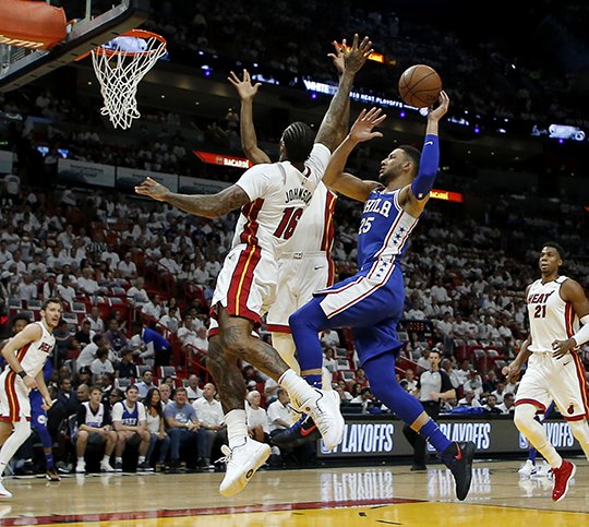 Philadelphia 76ers guard Ben Simmons (25) shoots in the first quarter as Miami Heat forward James Johnson (16) defends in Game 4 of a first-round NBA basketball playoff series, Saturday, April 21, 2018, in Miami. (AP Photo/Joe Skipper)