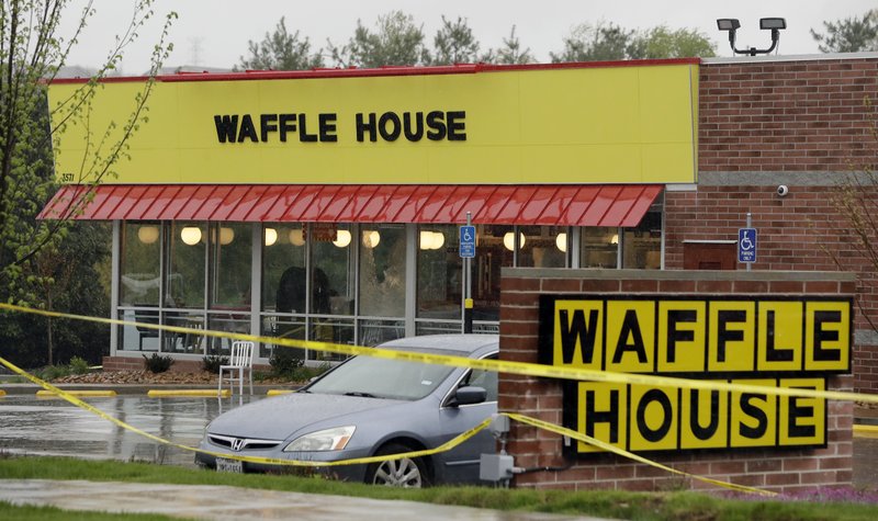 Police tape blocks off a Waffle House restaurant Sunday, April 22, 2018, in Nashville, Tenn. At least four people died after a gunman opened fire at the restaurant early Sunday.(AP Photo/Mark Humphrey)