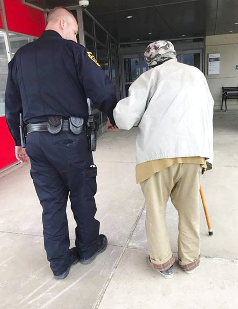 In this April 19, 2018, photo provided by the Montoursville Police Department in Montoursville, Pa., Jason Bentley, left, deputy chief of the department, escorts an 84-year-old man to see his wife, also 84, in the emergency department of UPMC Susquehanna hospital in Williamsport, Pa. After the elderly man's wife had a medical emergency and was taken from the couple's home by ambulance, Montoursville Police Chief Jeff Gyurina said he gave the man a patrol car's cellphone number because the man couldn't drive anymore and had no family in the area to take him to the hospital. (Montoursville Police Department via AP)