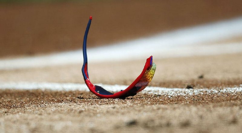 Kris Bryant’s broken sunglasses lie on the field after the Chicago Cubs slugger was hit in the helmet by a pitch from German Marquez of the Colorado Rockies on Sunday in Denver. 