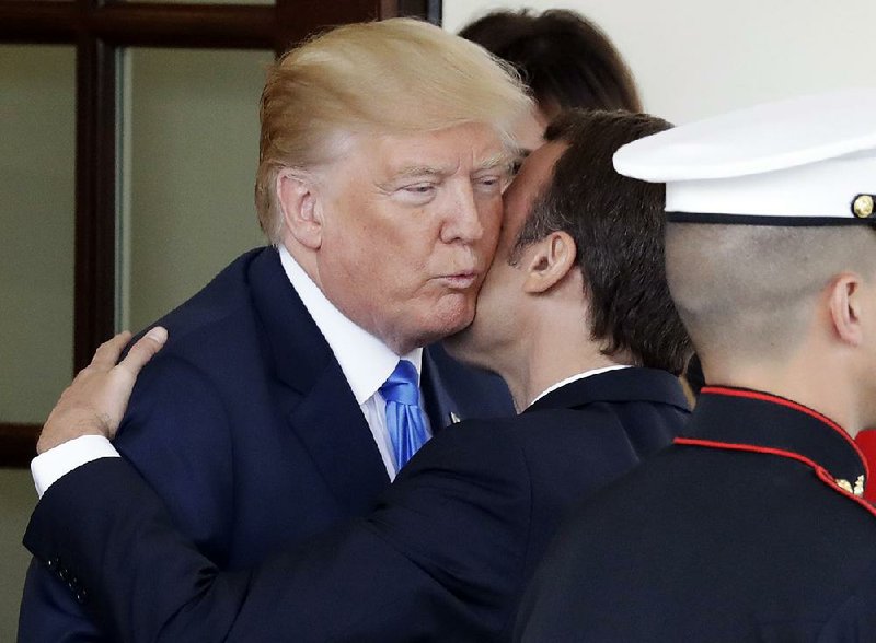 President Donald Trump greets French President Emmanuel Macron at the White House on Monday in Washington. 
