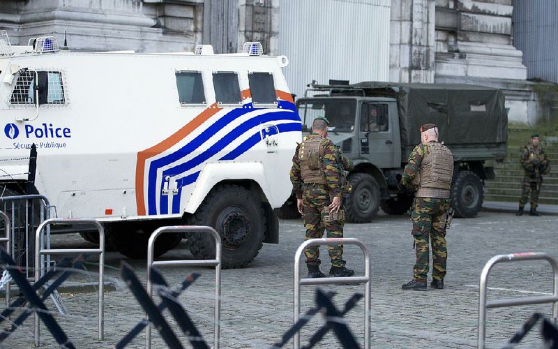Police and Belgian army soldiers patrol outside the Brussels justice palace during the trial of Salah Abdeslam and Soufiane Ayari on Monday. 
