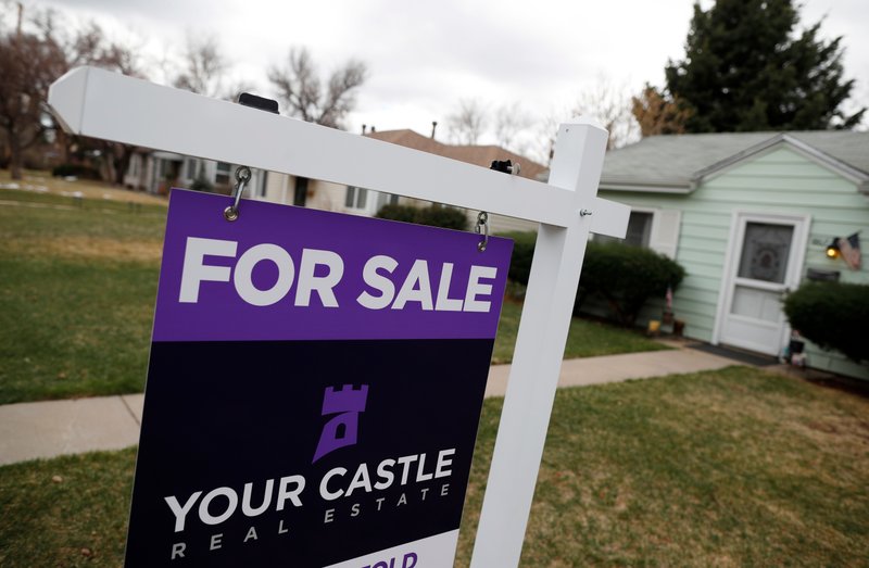 FILE- In this March 28, 2018, file photo, a for sale sign is shown outside a single-family home on the market in Denver. On Monday, April 23, the National Association of Realtors reports on March sales of existing homes. (AP Photo/David Zalubowski, File)