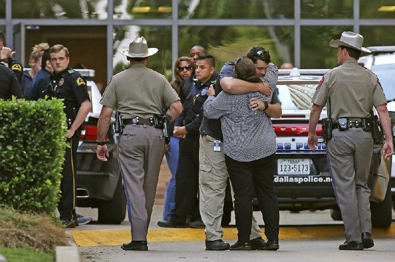 Dallas police gather Tuesday outside the emergency room at Texas Health Presbyterian Hospital where two injured officers were being treated. 