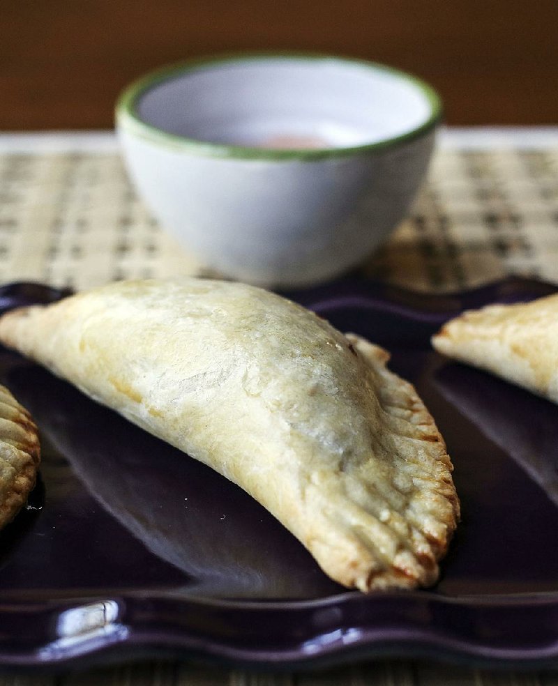 Chicken Empanadas, served with tangy Mayo-Ketchup Sauce, feature adobo-seasoned chicken, sofrito and green olives and are brushed with egg wash before baking. 