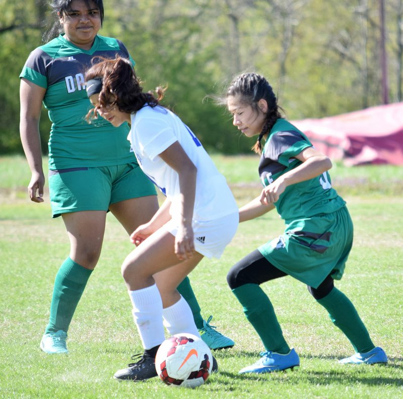 Westside Eagle Observer/MIKE ECKELS Decatur's Kaylee Morales back passes the ball in an attempt to keep it from two Danville players during the April 10 soccer match between Decatur and Danville in Decatur.