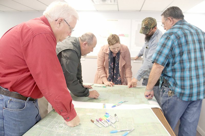 LYNN KUTTER ENTERPRISE-LEADER Juliet Richey with Brooks Landscape Architecture and Planning helps city officials look over a map of Lincoln to see how areas may be used in the future. Future land uses include historic square, mixed use, residential medium density, light industrial. They also identified possible places for trails, sidewalks and street connections. Meeting with Richey are Council members Doug Moore, Mayor Rob Hulse, Doug Hutchens and Johnny Stowers.