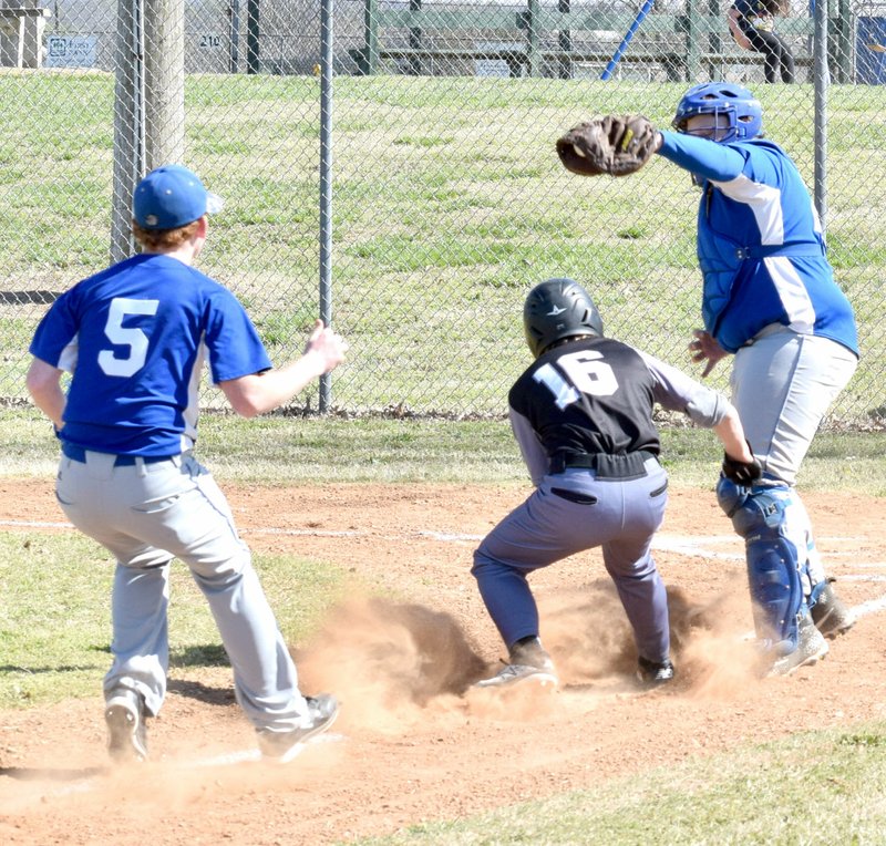 Westside Eagle Observer/MIKE ECKELS A Jasper base runner tries to steal home but instead finds himself caught between Austin Hamilton (Decatur 5) and Bryan Ward (Decatur catcher) in the top of the first inning of the Decatur-Jasper baseball contest at Edmiston Park in Decatur April 16. There was no escape for the Pirate player who was tagged out by Ward.