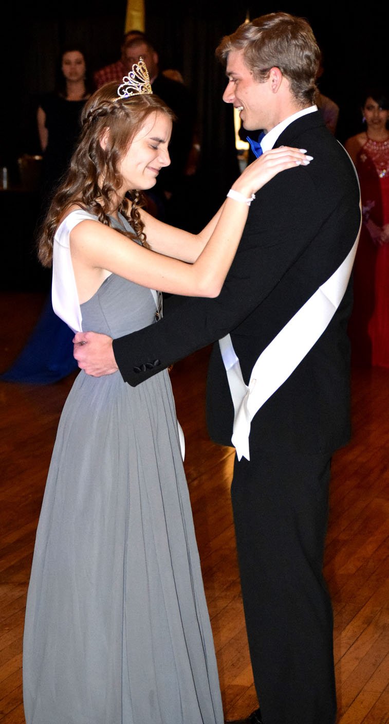 Westside Eagle Observer/MIKE ECKELS Emily Lydon (left) and Taylor Haisman share their first dance as prom king and queen during the 2018 Decatur High School junior-senior prom in Siloam Springs April 21.