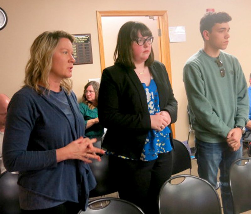 Westside Eagle Observer/SUSAN HOLLAND Robin Hilger (left), HOSA Club sponsor at Gravette High School, and two of her students, Amy Whiteside and Kade Jarvis, attend the April meeting of the Gravette School Board.
