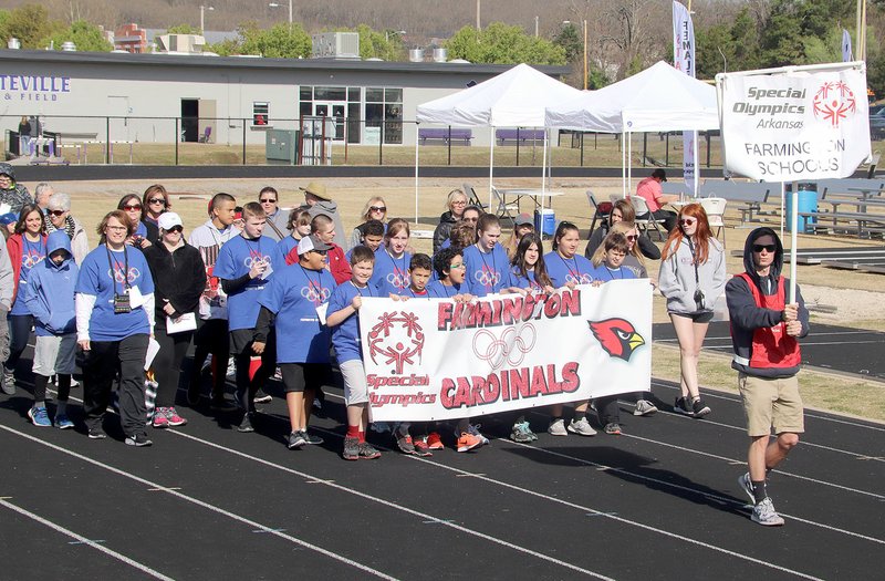 LYNN KUTTER ENTERPRISE-LEADER Farmington's student athletes for the regional competition for Special Olympics Arkansas walk around the track for the opening ceremonies on Friday morning in Fayetteville. Farmington had student athletes from Ledbetter Intermediate, Lynch Middle School and Farmington High.