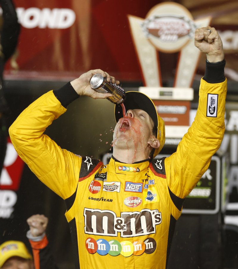 Kyle Busch celebrates in Victory Lane after winning the NASCAR Cup Series auto race at Richmond Raceway in Richmond, Va., Saturday, April 21, 2018. (AP Photo/Steve Helber)