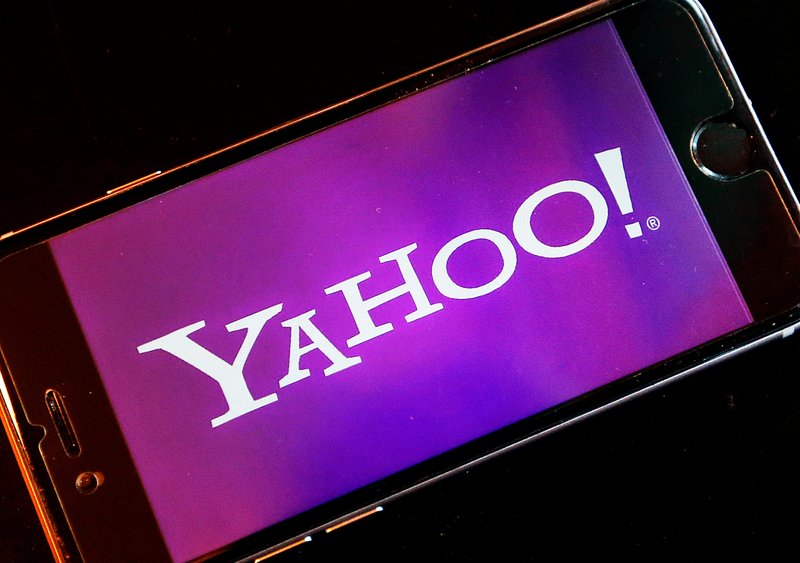 FILE - In this Dec. 15, 2016, file photo, the Yahoo logo appears on a smartphone in Frankfurt, Germany. The company formerly known as Yahoo is paying a $35 million fine to resolve federal regulators' charges that the online pioneer deceived investors by failing to disclose one of the biggest data breaches in internet history.  (AP Photo/Michael Probst, File)