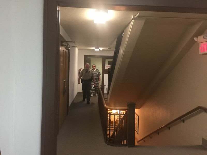 NWA Democrat-Gazette/TRACY M. NEAL Ted Meehan, 31, of Siloam Springs pleaded no contest Thursday in connection with his father's death. Deputies escort Meehan from court after he was sentenced to 20 years in prison.
