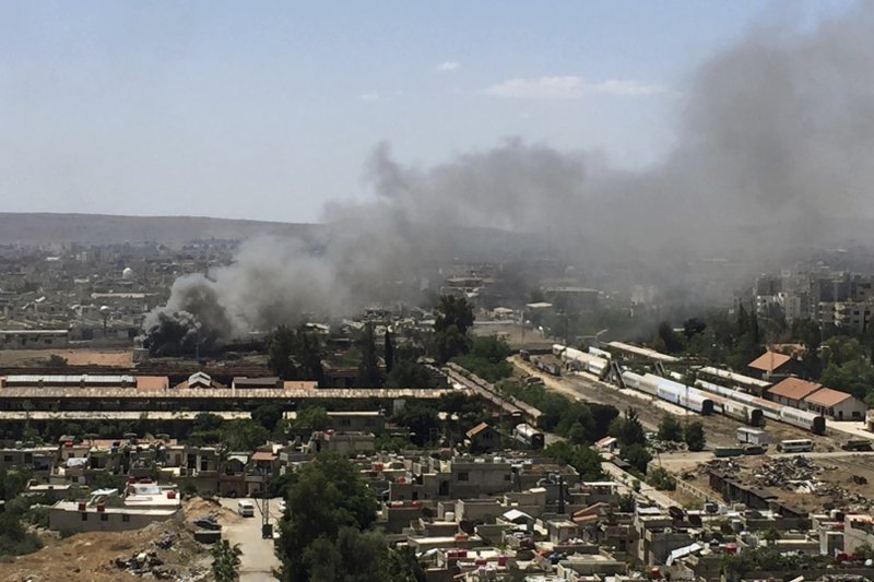 Smoke rises after Syrian government airstrikes and shelling hit in Hajar al-Aswad neighborhood held by Islamic State militants, southern Damascus, Syria, Tuesday, April 24, 2018. Syrian state TV is reporting that government forces have launched a new operation targeting underground tunnels used by the Islamic State group in the capital, Damascus. (AP Photo)