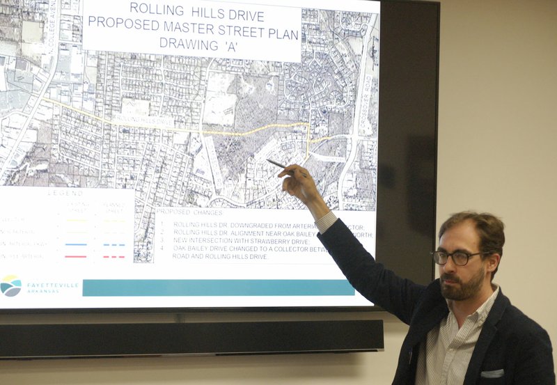 NWA Democrat-Gazette/STACY RYBURN Matthew Petty, Ward 2 representative and chairman of the Fayetteville City Council Transportation Committee, points Tuesday to a map of a proposed connection on the city's overall street plan involving Rolling Hills Drive in northeast Fayetteville.