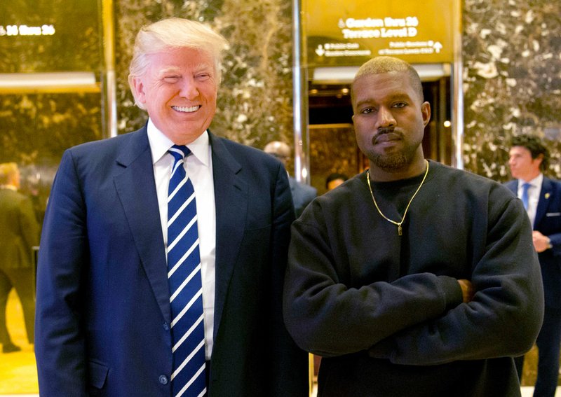 In this Dec. 13, 2016, file photo, then-President-elect Donald Trump and Kanye West pose for a picture in the lobby of Trump Tower in New York. Trump is tweeting his thanks to rap superstar Kanye West for his recent online support. Trump wrote, “Thank you Kanye, very cool!” in response to the tweets from West, who called the president “my brother.” West tweeted a number of times Wednesday expressing his admiration for Trump, saying they both share “dragon energy.” The rap star also posted a photo of himself wearing Trump’s campaign “Make America Great Again” hat. (AP Photo/Seth Wenig, File)
