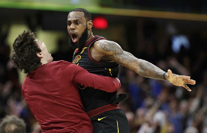 LeBron James (left) celebrates with Cleveland Cavaliers teammate Cedi Osman after hitting the winning three-pointer against the Indiana Pacers in Game 5 of their NBA playoff series Wednesday.  