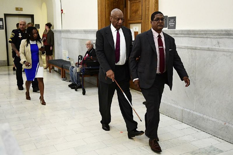 Bill Cosby’s publicist Ebonee Benson follows Cosby and his spokesman, Andrew Wyatt, during a break in Cosby’s sexual-assault trial Wednesday in Norristown, Pa.  