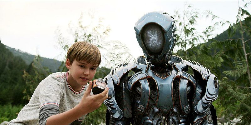 Netflix’s lavish reboot of Lost in Space features Max Jenkins as young Will Robinson, with Brian Steele inside the futuristic suit of Robot. 
